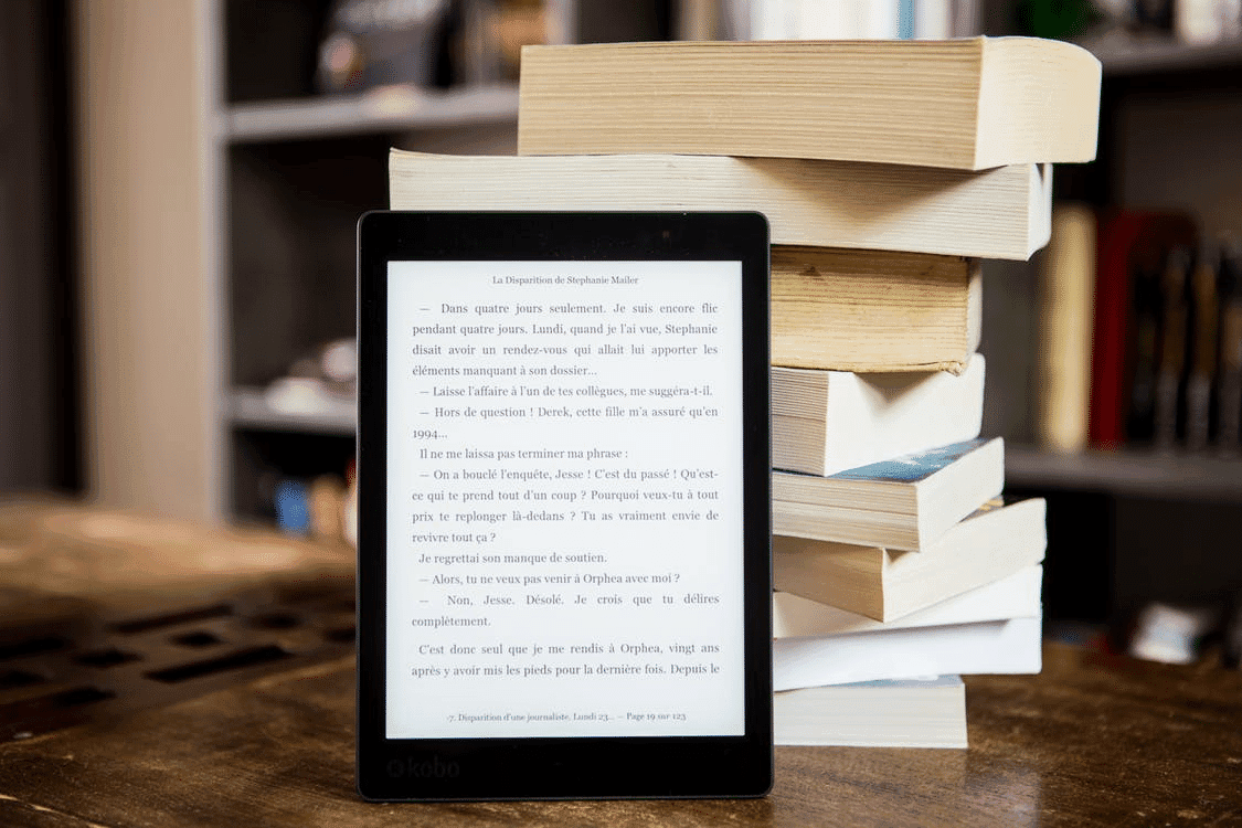 pile of books and ereader